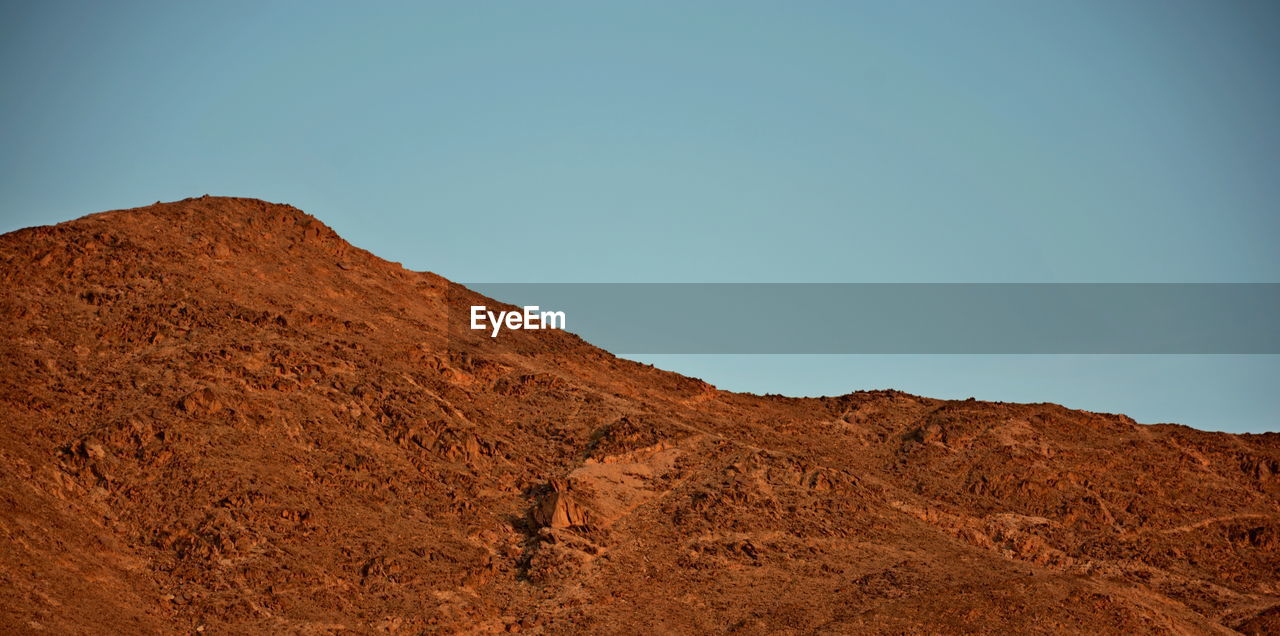 Low angle view of mountain against clear sky