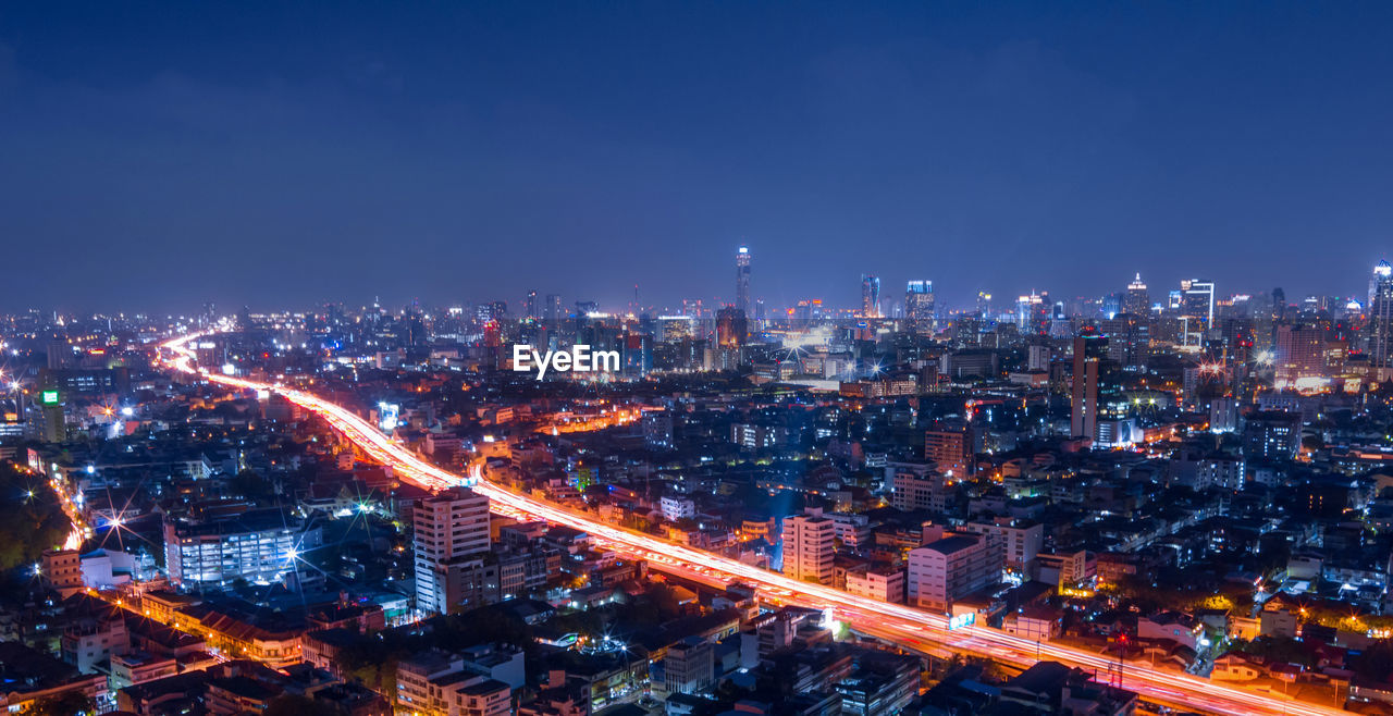 High angle view of illuminated city buildings at night