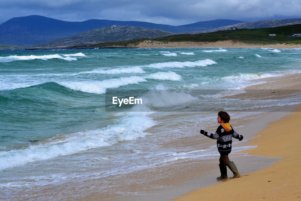 Rear view of boy on beach