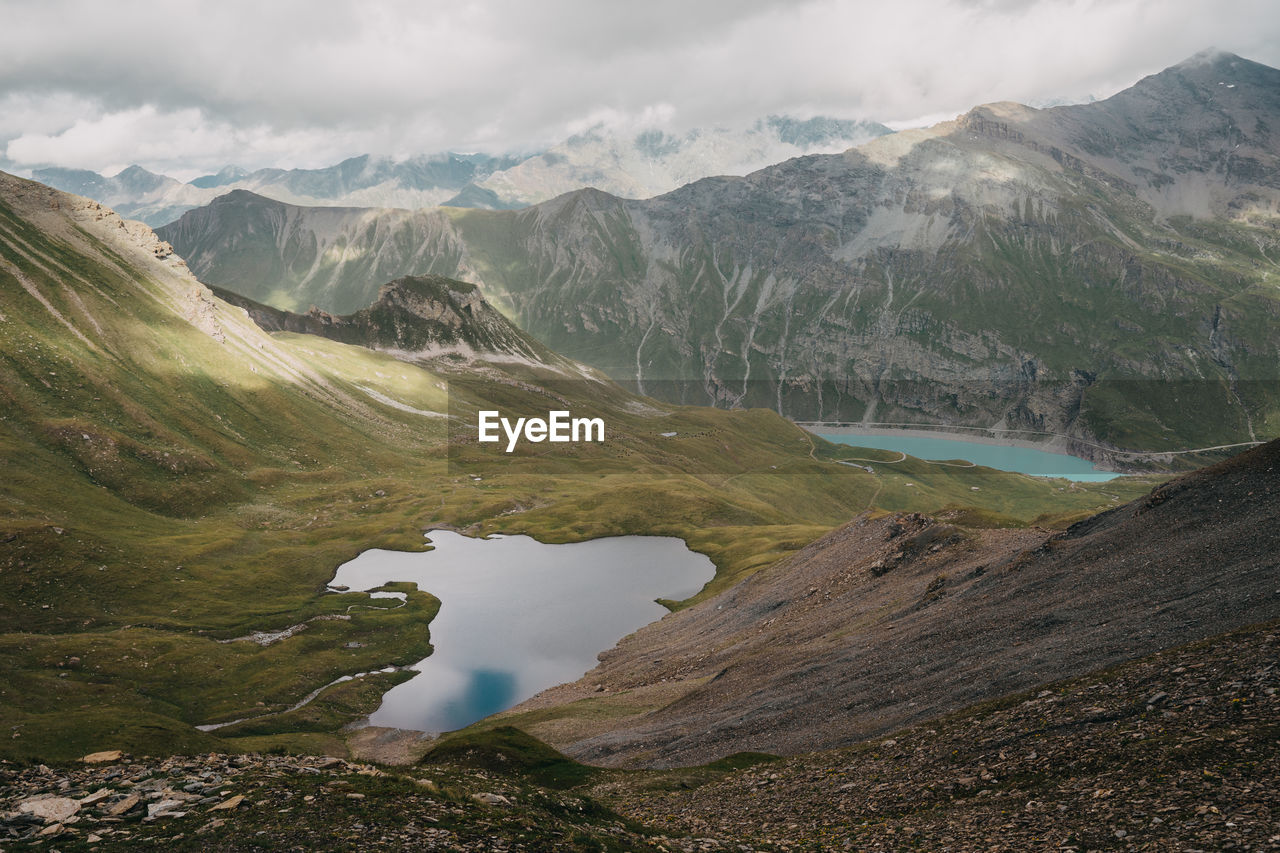 Scenic view of lake and mountains against sky