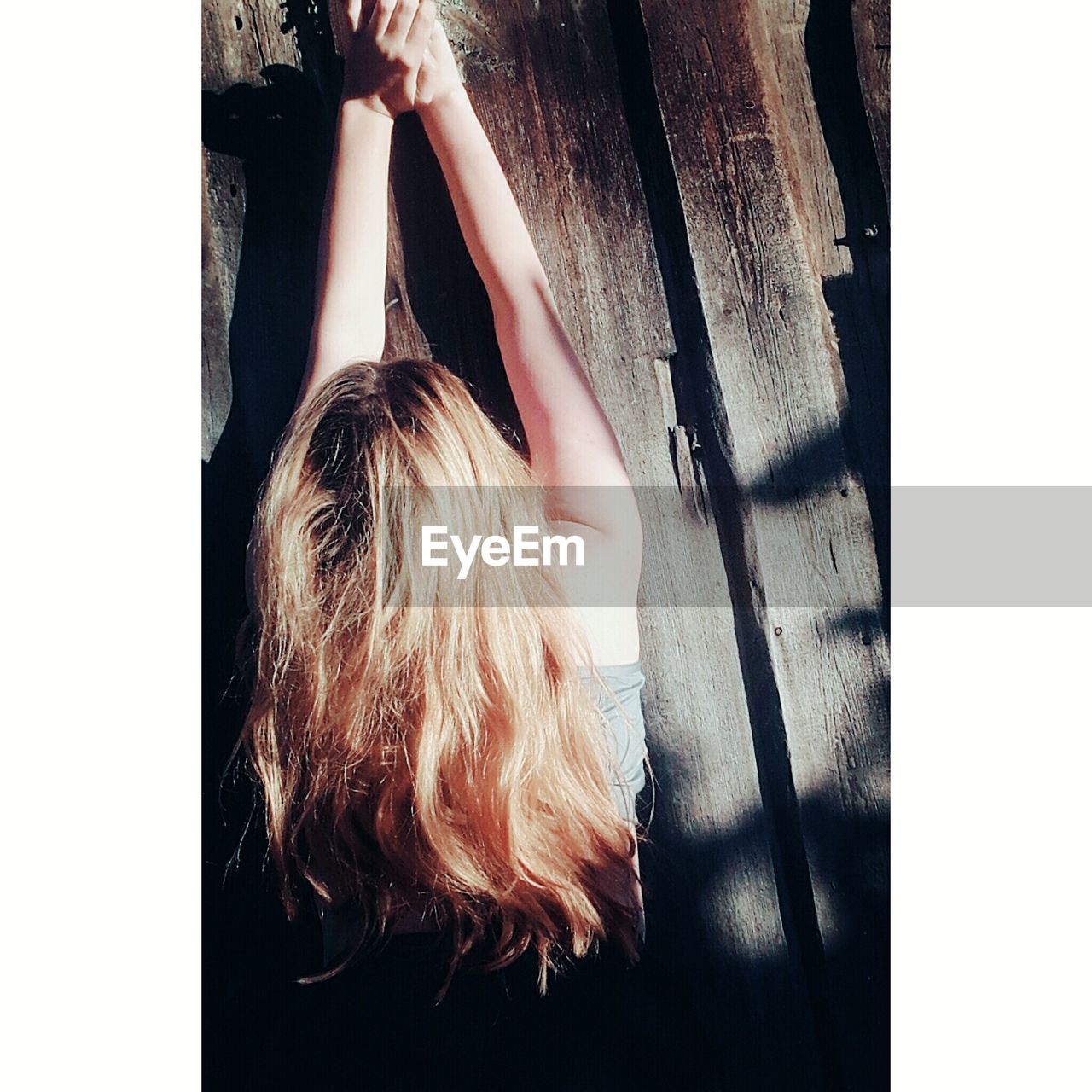 Directly above shot of woman lying on wooden table