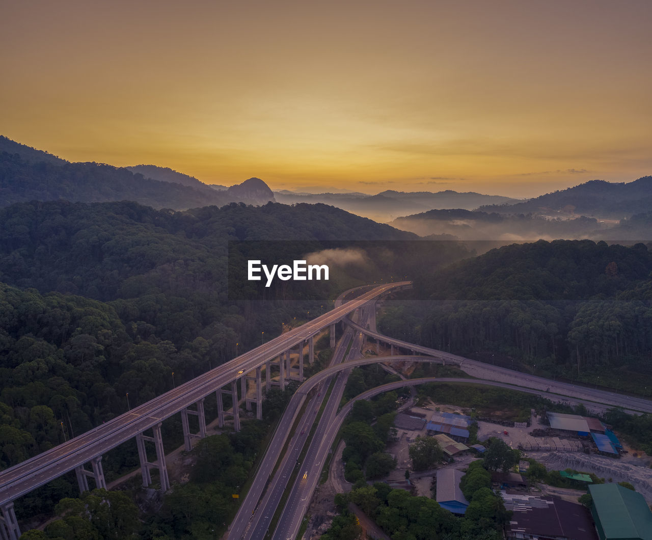 High angle view of bridge over mountains against sky during sunset