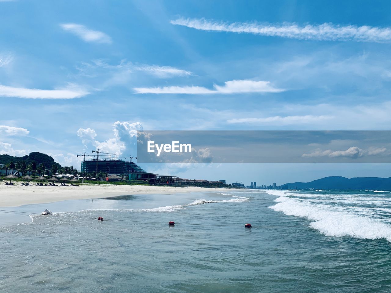 SCENIC VIEW OF BEACH AGAINST CLOUDY SKY