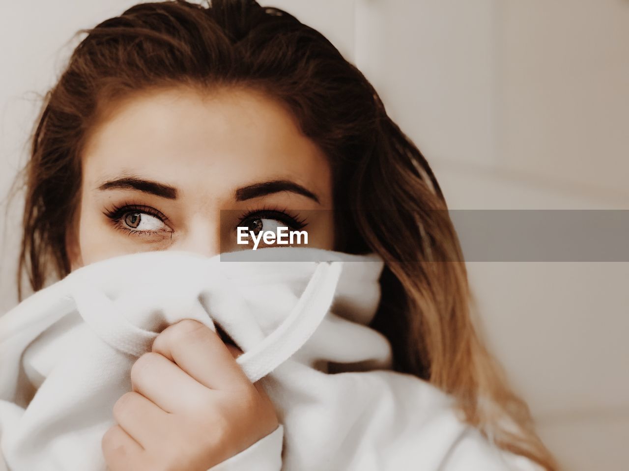 Close-up of beautiful young woman wearing hood