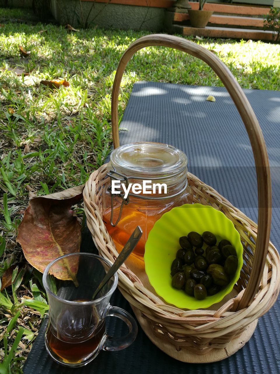 CLOSE-UP OF FRUITS IN BASKET WITH GLASS