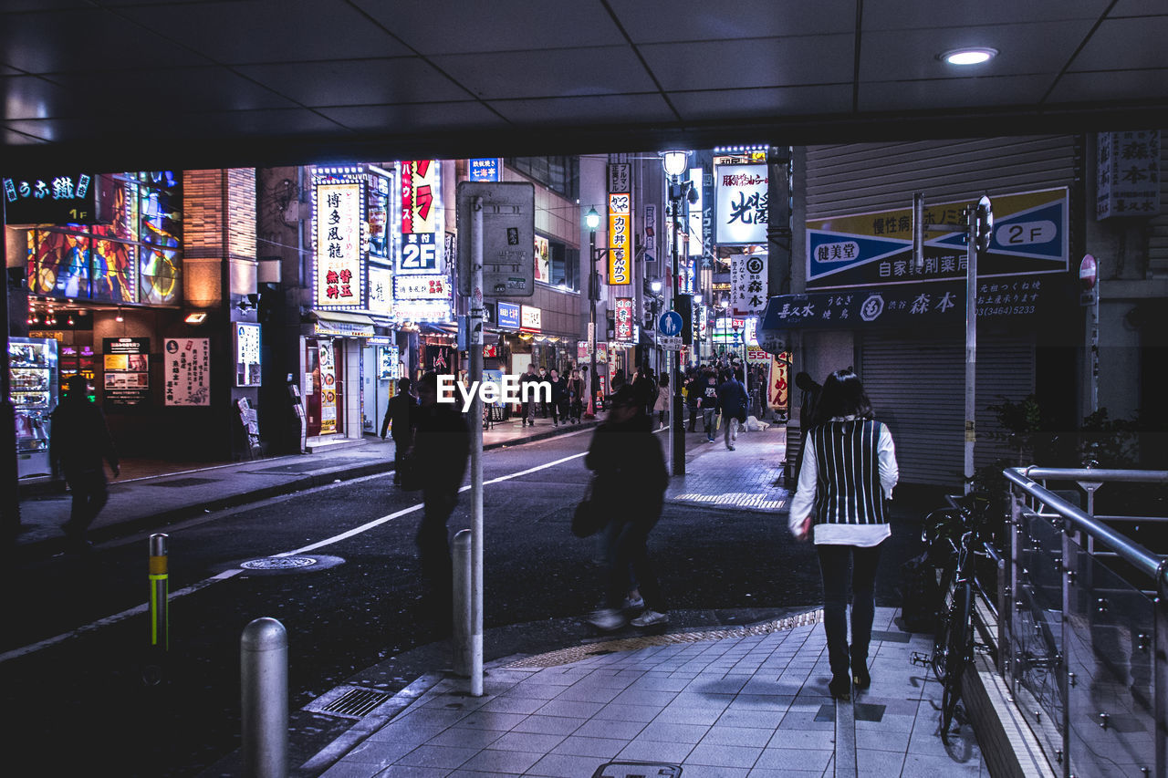 People walking in city at night