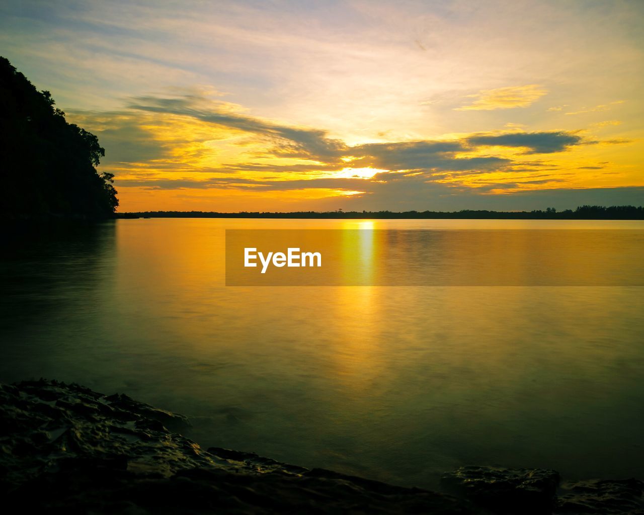 SCENIC VIEW OF LAKE AGAINST ORANGE SKY