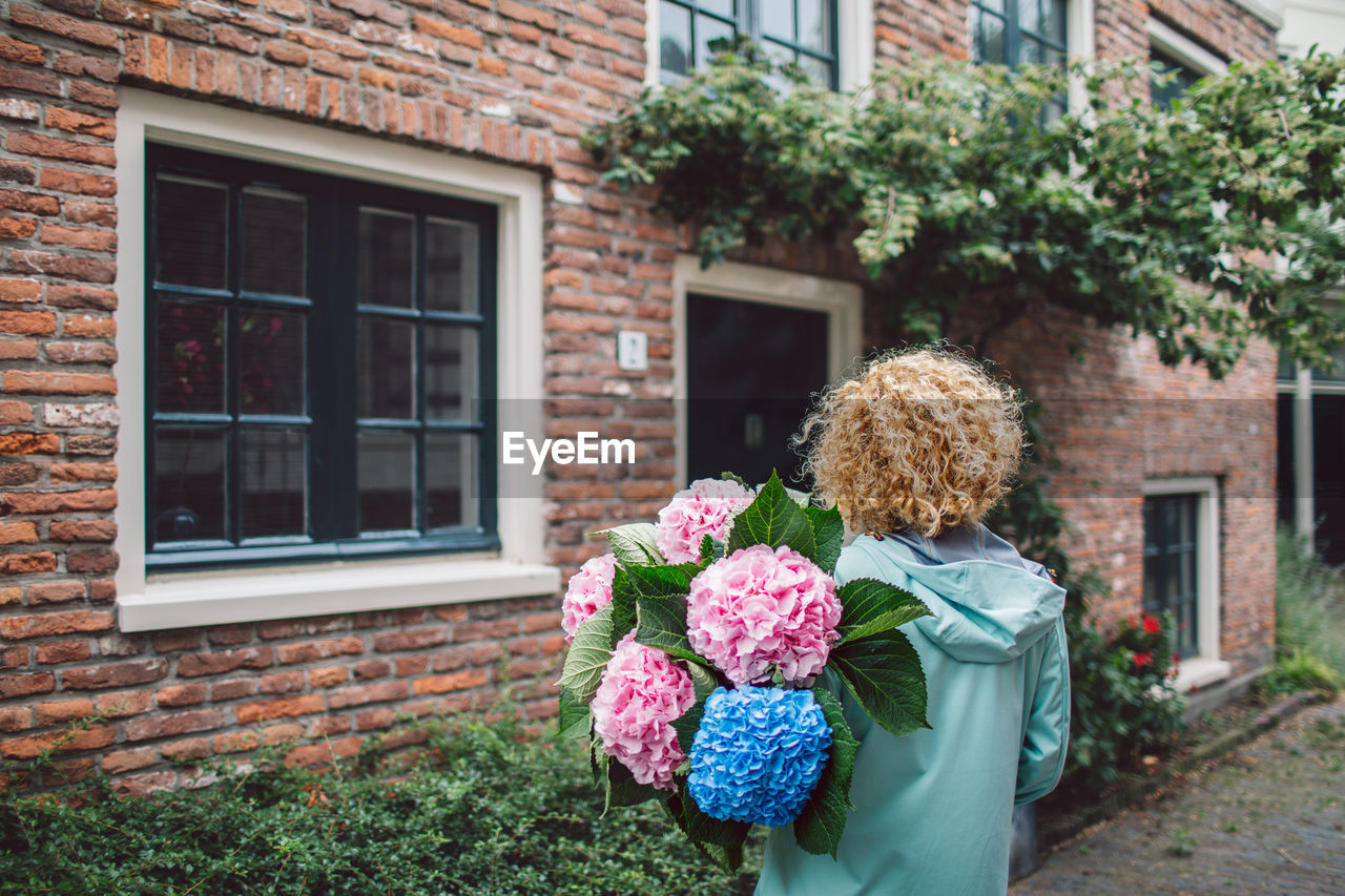 rear view of woman holding bouquet