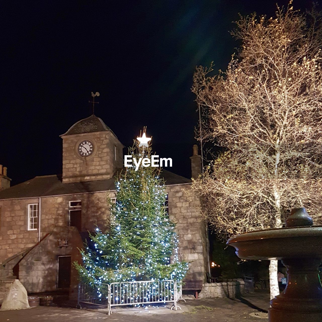ILLUMINATED CHRISTMAS TREE AT NIGHT DURING FESTIVAL