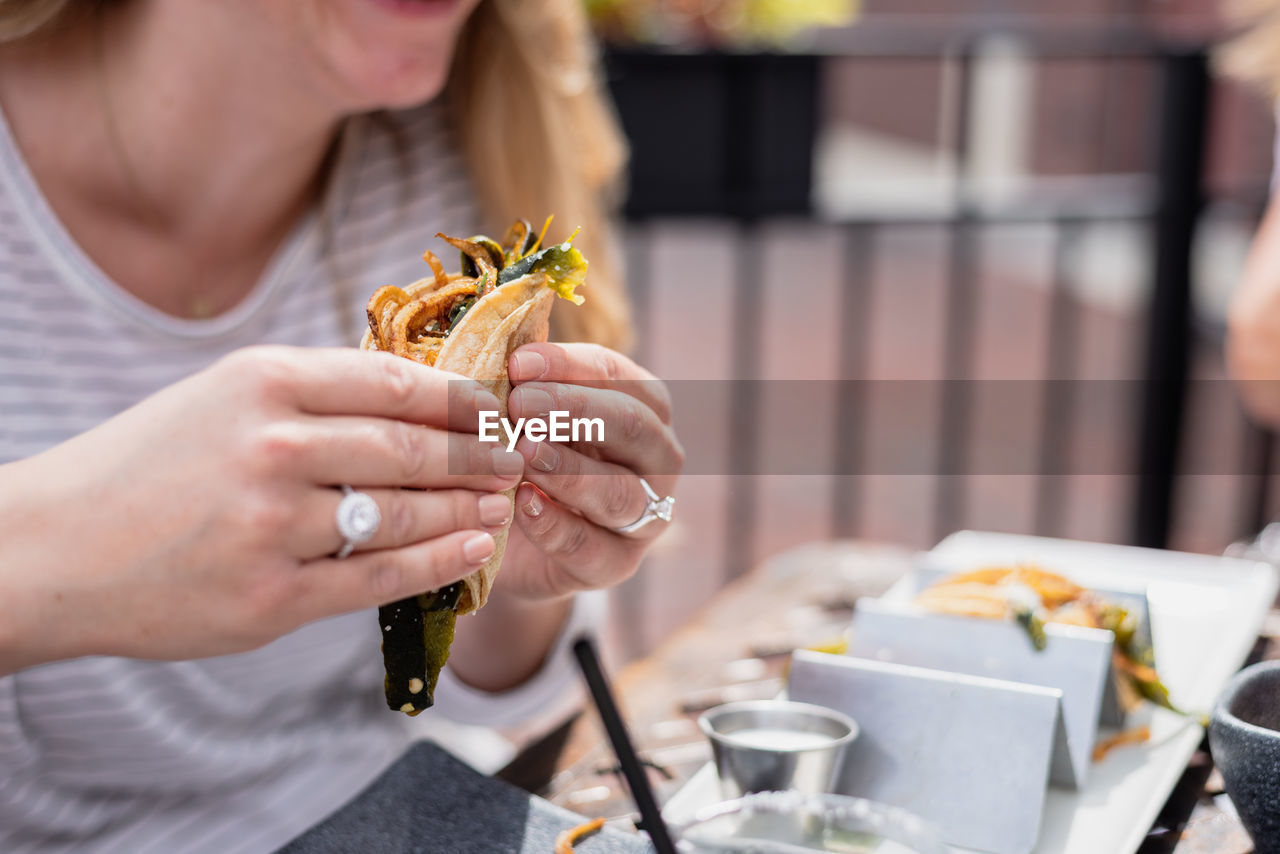 Midsection of woman holding food outdoors