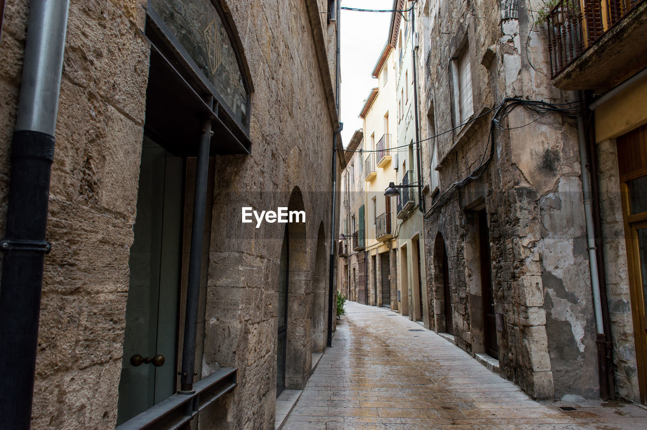 Narrow alley amidst old buildings in city