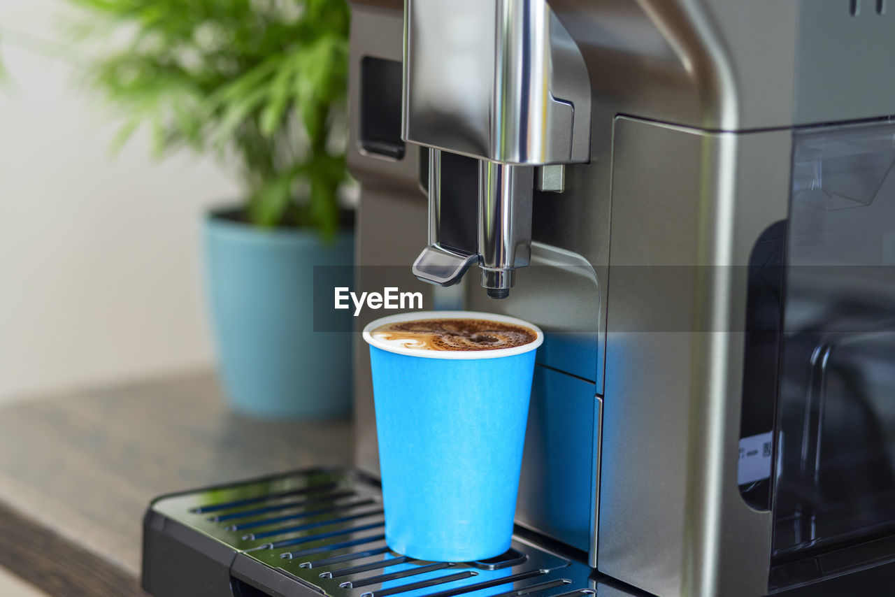 close-up of coffee pouring in cafe