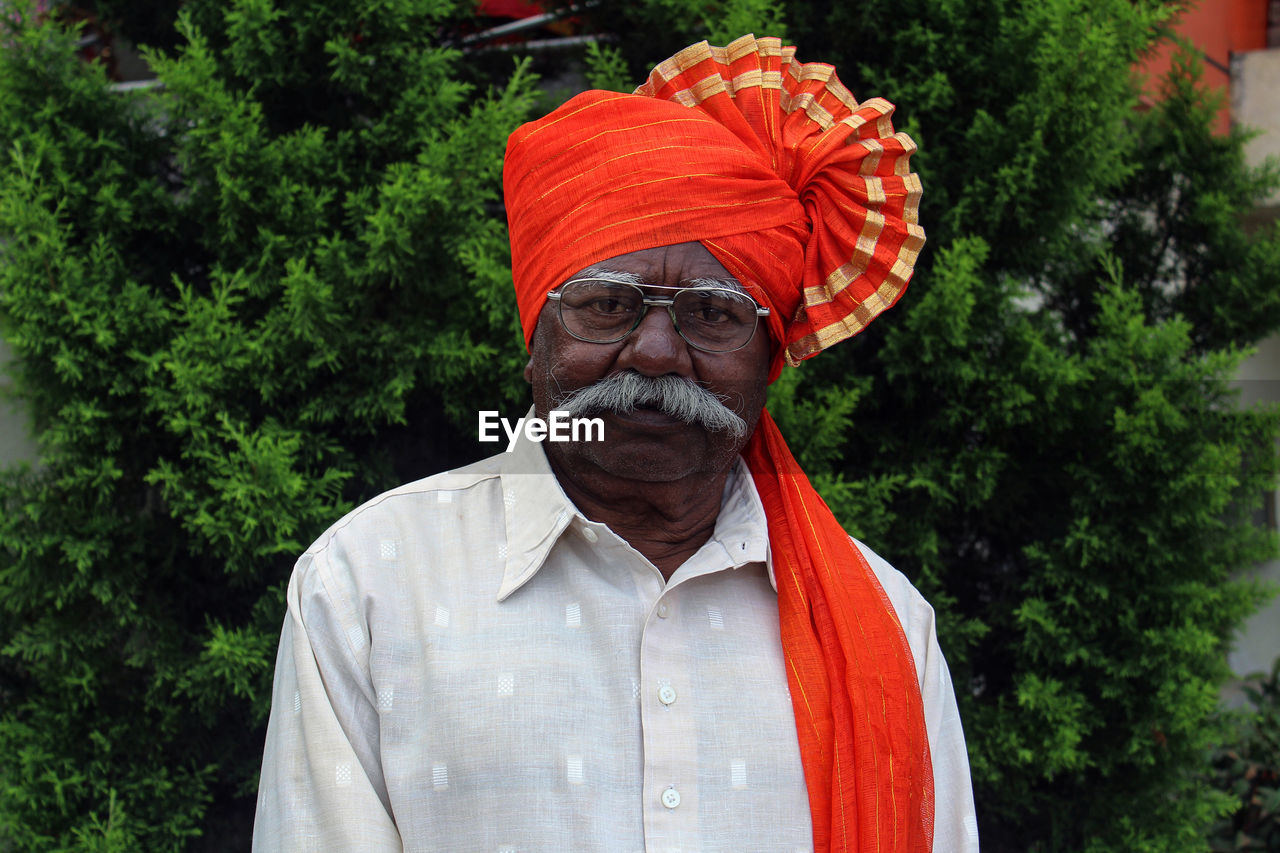 Portrait of senior man against plants