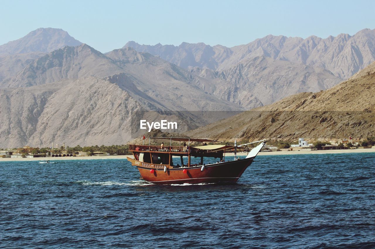 SCENIC VIEW OF BOATS IN SEA