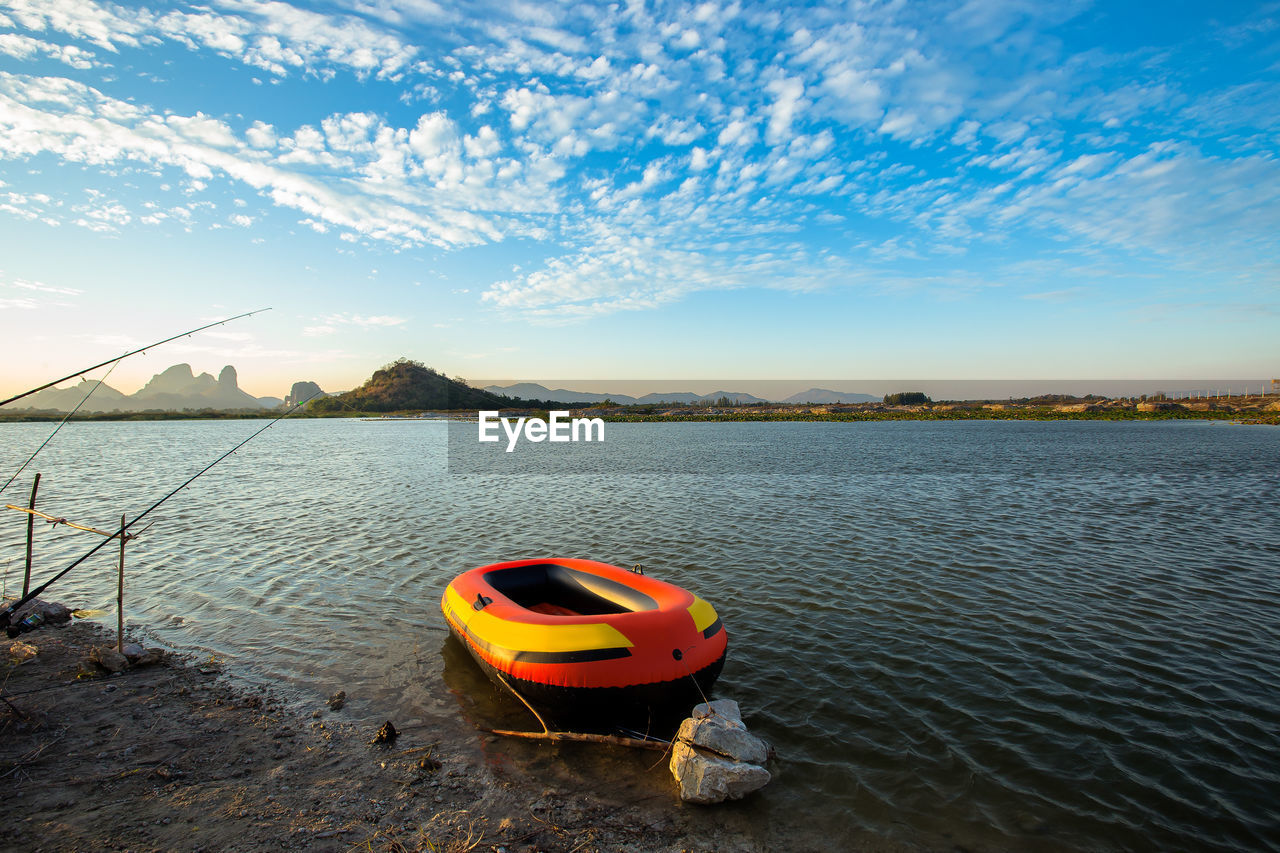 BOAT IN LAKE AGAINST SKY