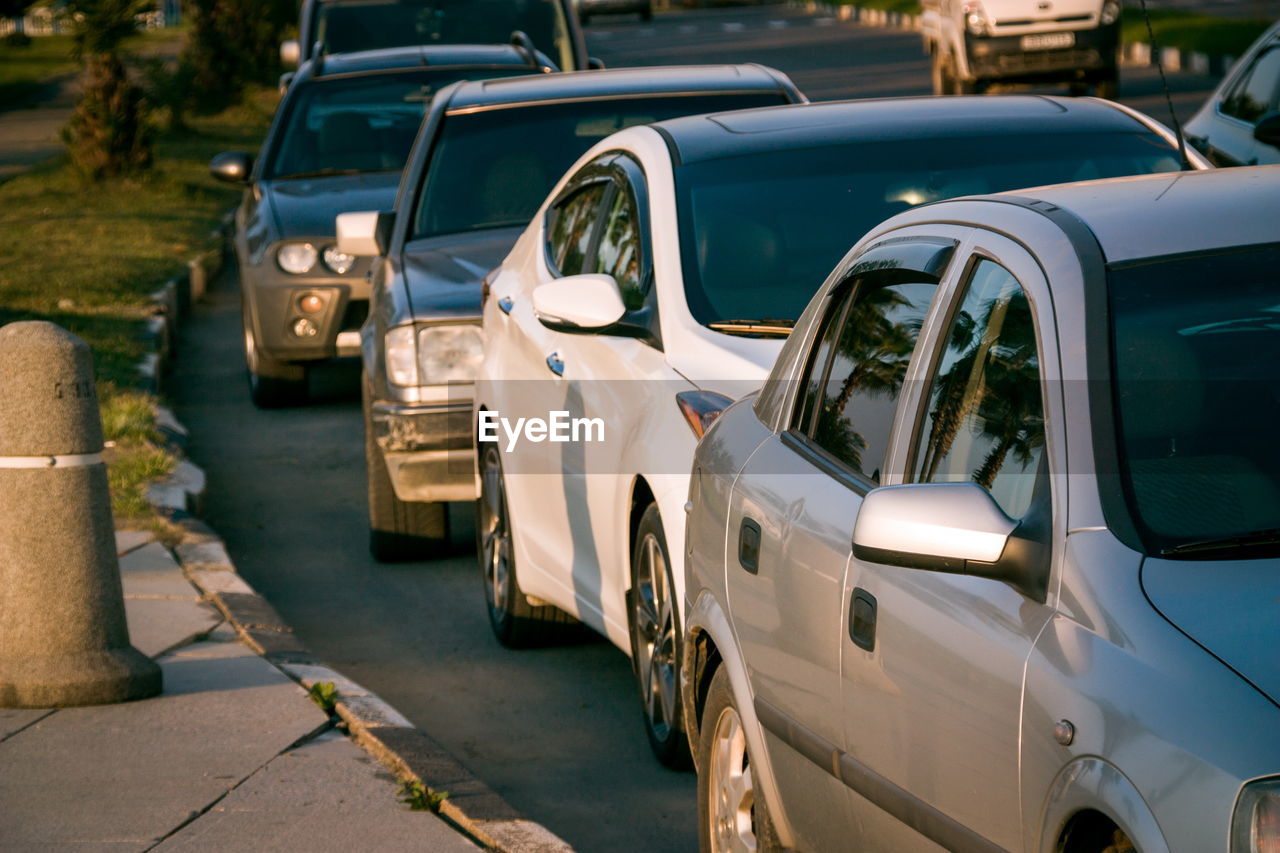 Cars in row on road