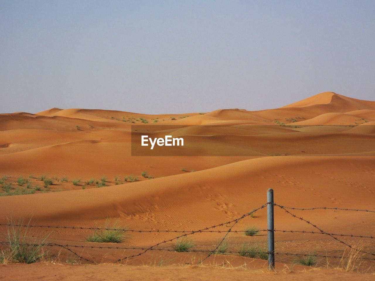 View of sand dunes against clear sky