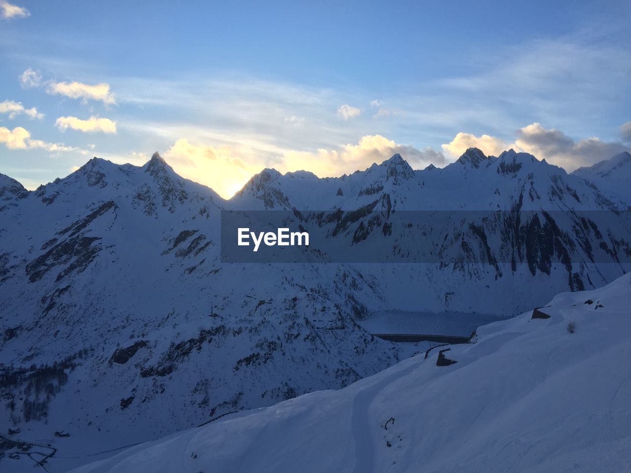 Scenic view of snow covered mountains against sky