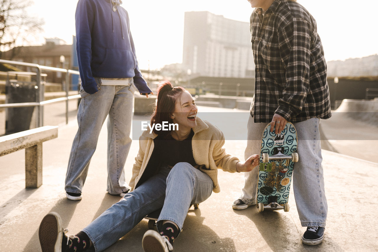 Laughing teenage girls in skatepark