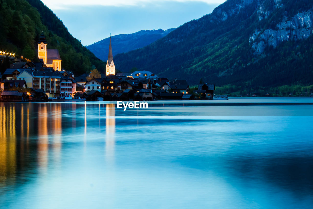 Scenic view of lake by mountain against sky