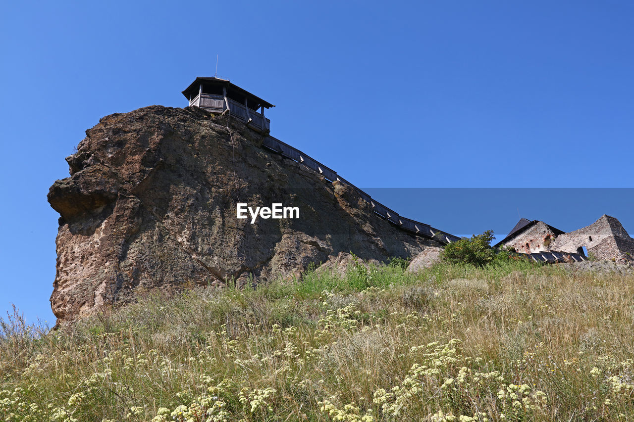 Low angle view of boldogko castle against clear blue sky