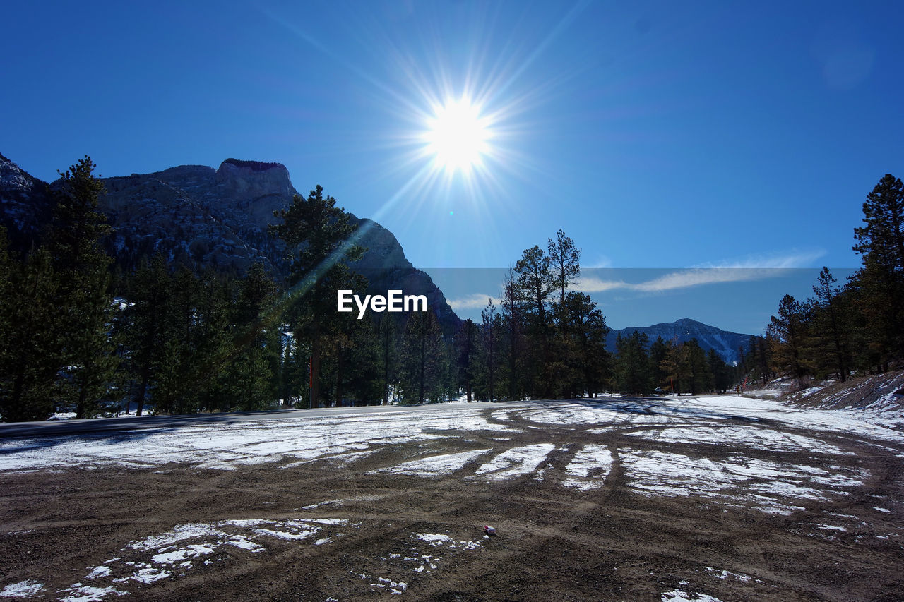 SCENIC VIEW OF SNOWCAPPED MOUNTAINS AGAINST BLUE SKY