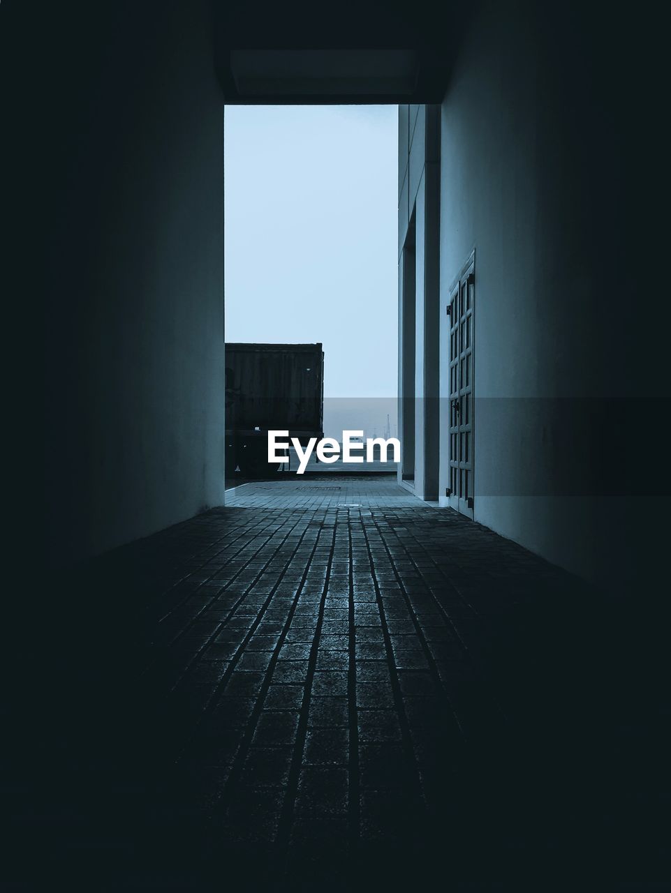 Empty corridor of building against clear sky