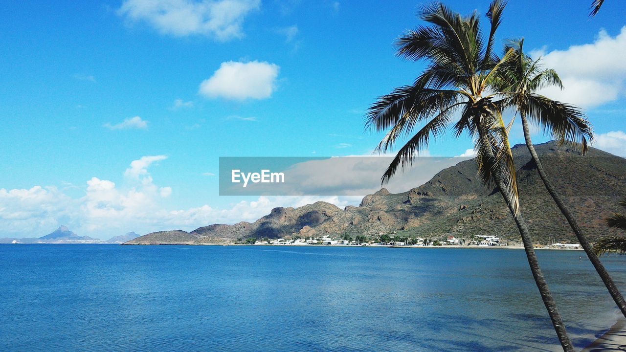 Scenic view of sea and mountains against sky