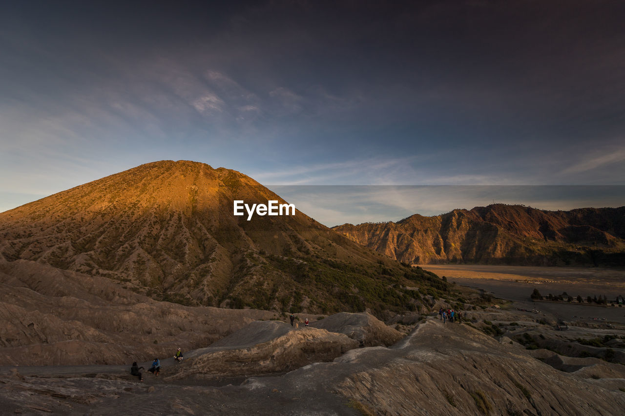 Scenic view of desert against sky during sunset