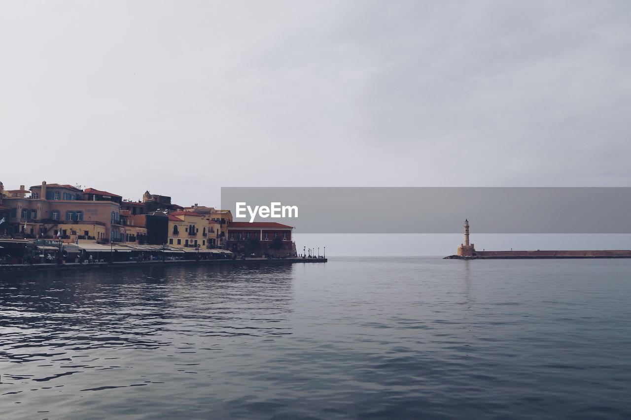 Scenic view of sea and buildings against sky