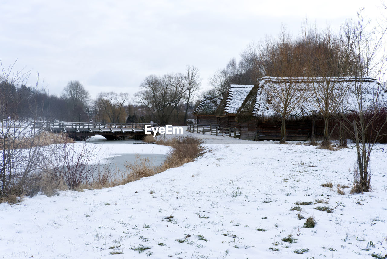 snow, winter, cold temperature, nature, tree, sky, plant, no people, architecture, bare tree, environment, built structure, day, scenics - nature, white, tranquility, frozen, freezing, beauty in nature, land, tranquil scene, landscape, water, non-urban scene, outdoors, building exterior, field