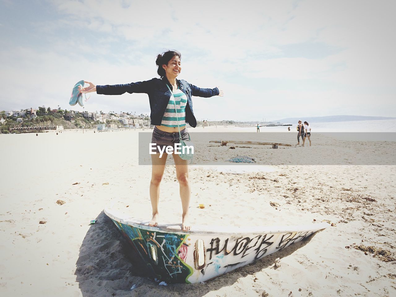 WOMAN STANDING ON BEACH