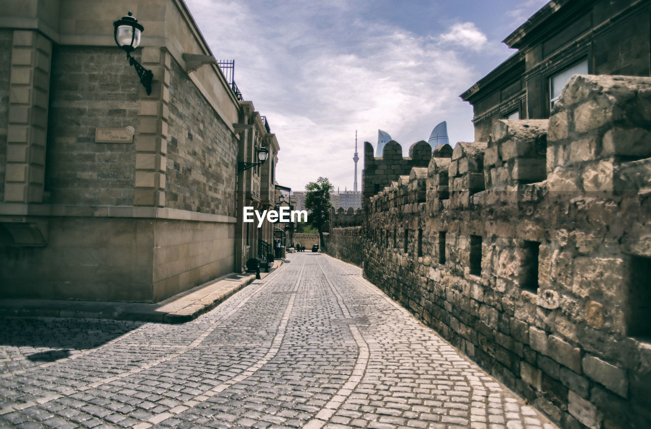 Empty street by building