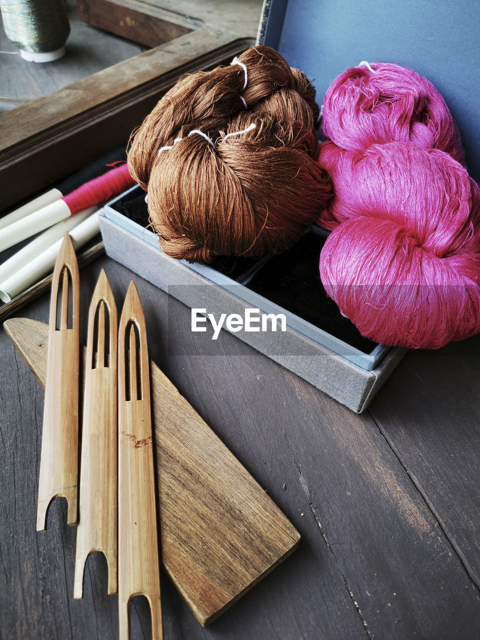 HIGH ANGLE VIEW OF WOMAN ON TABLE BY WOODEN FLOOR