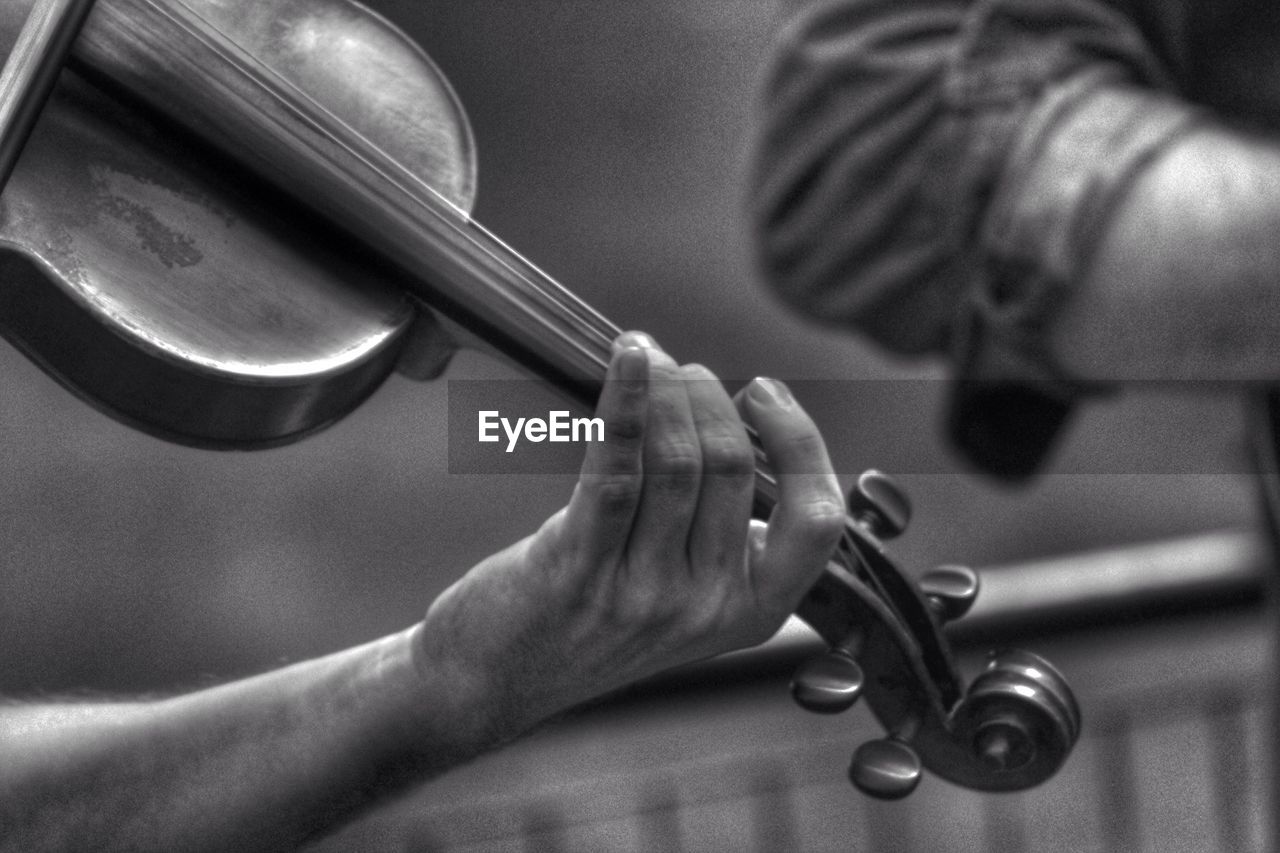 Close-up of hand playing violin