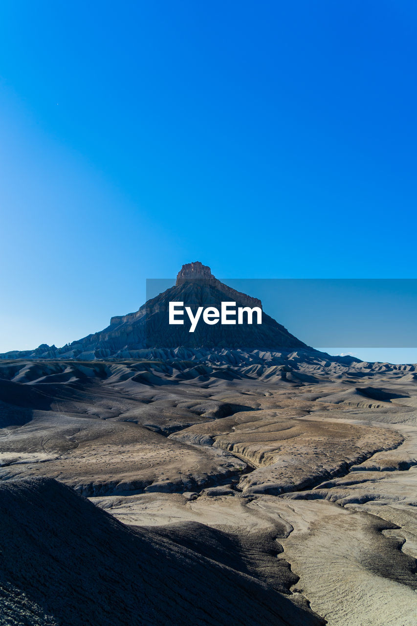 Scenic view of snowcapped mountains against clear blue sky