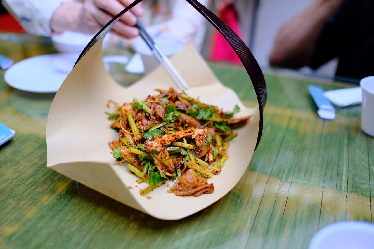 Midsection of people eating food at table