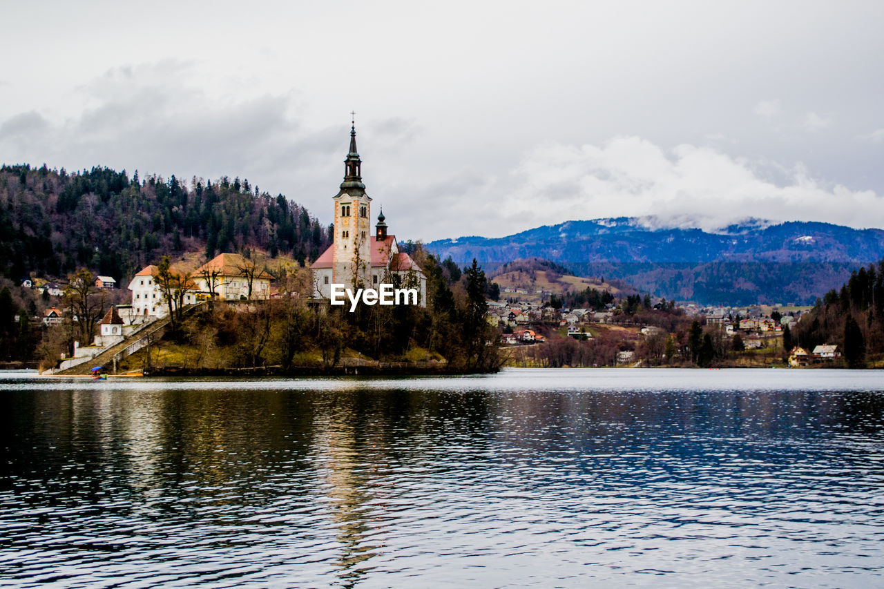 LAKE BY BUILDING AGAINST SKY