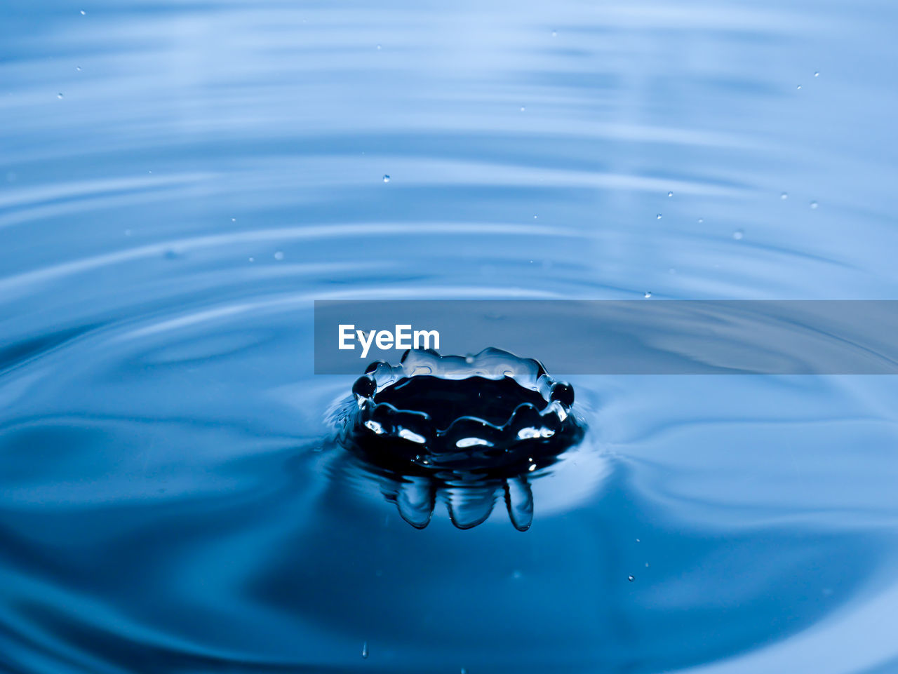 High angle view of drop falling on water