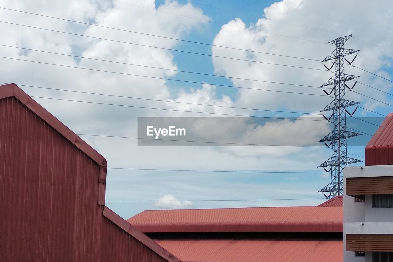 LOW ANGLE VIEW OF TELEPHONE POLE BY BUILDING AGAINST SKY