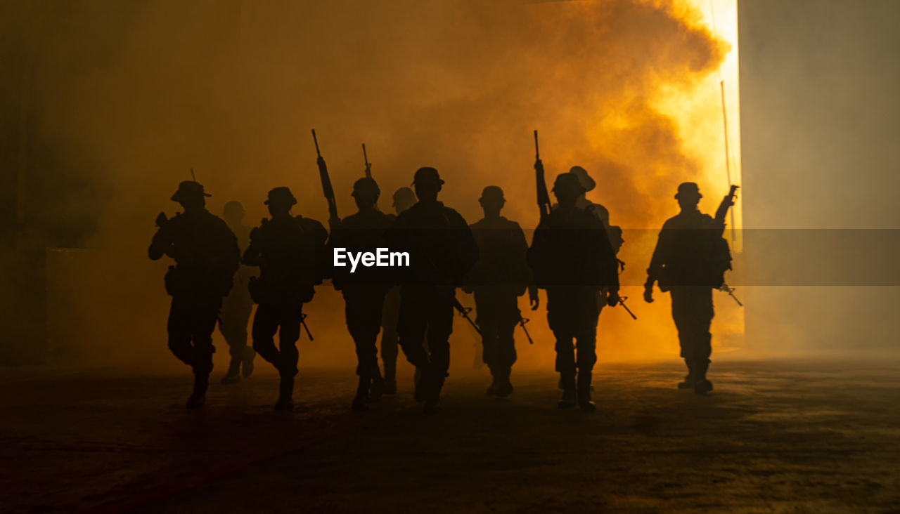 Soldiers with weapons on military combat training