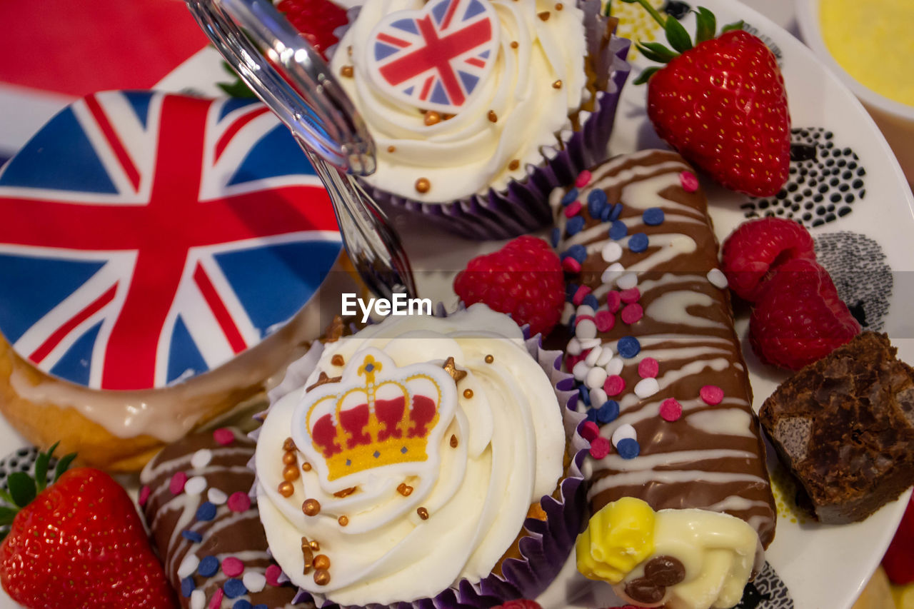 food, food and drink, sweet food, sweet, dessert, cake, no people, berry, fruit, baked, freshness, strawberry, still life, indoors, table, multi colored, variation, temptation, flag, celebration, chocolate, unhealthy eating, close-up, plate, patriotism, high angle view, birthday cake