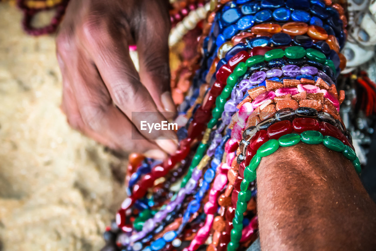 Close-up of man selling jewelry outdoors