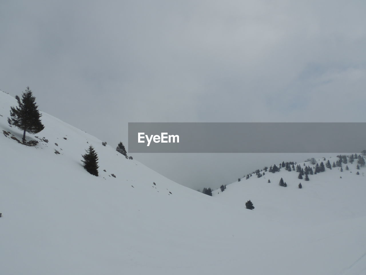 Scenic view of snow covered mountain against sky