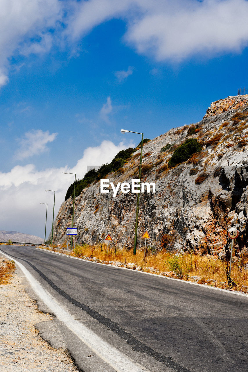 Empty road by mountain