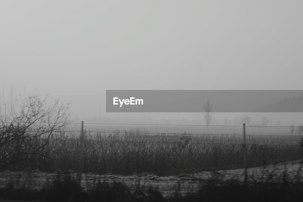 Scenic view of field against cloudy sky