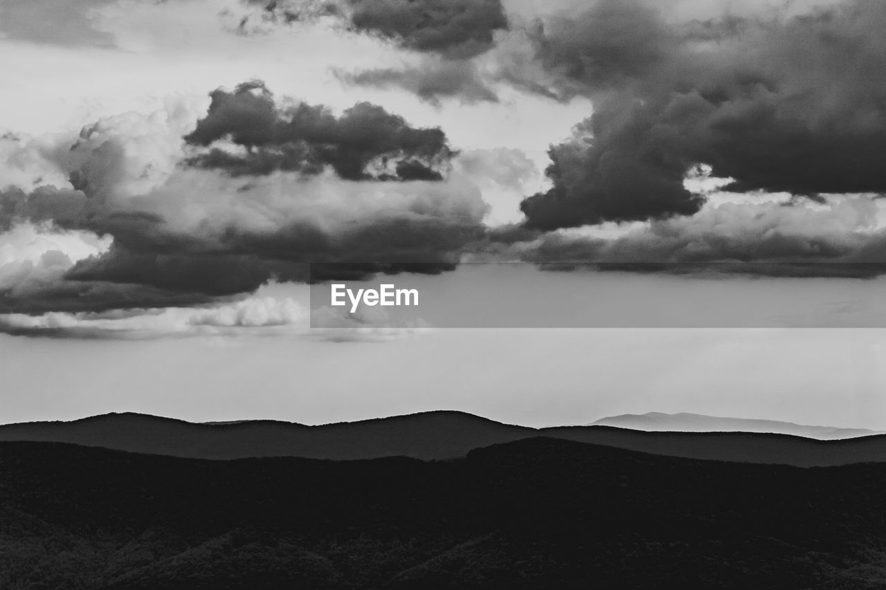 SCENIC VIEW OF DRAMATIC SKY OVER SILHOUETTE MOUNTAINS