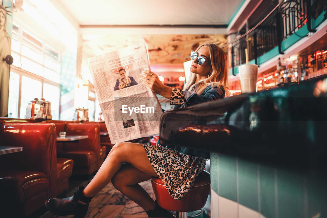 WOMAN SITTING IN THE WINDOW