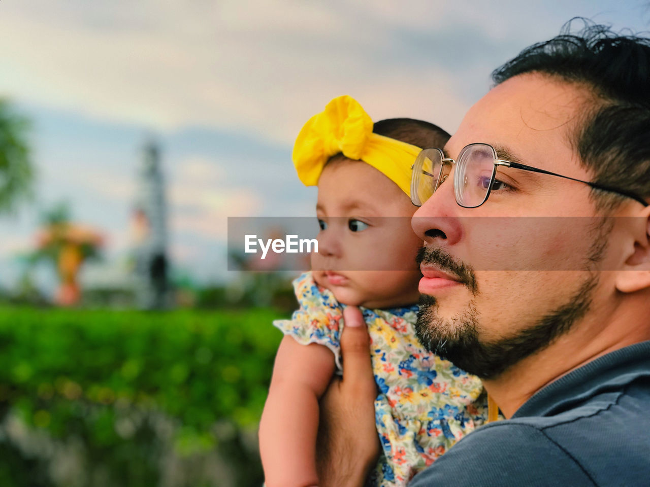 close-up of young woman looking away while standing outdoors