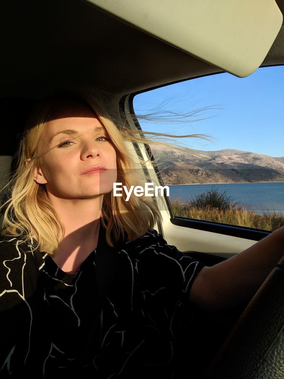 Portrait of beautiful woman in car